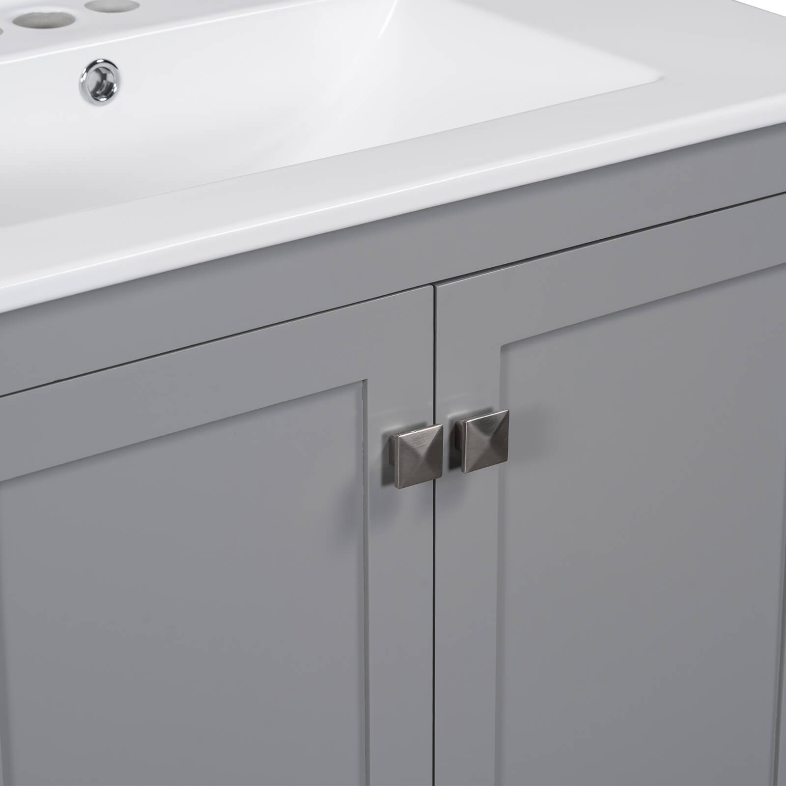 Detail of handles on a 30 inch grey bathroom vanity with built-in shelves