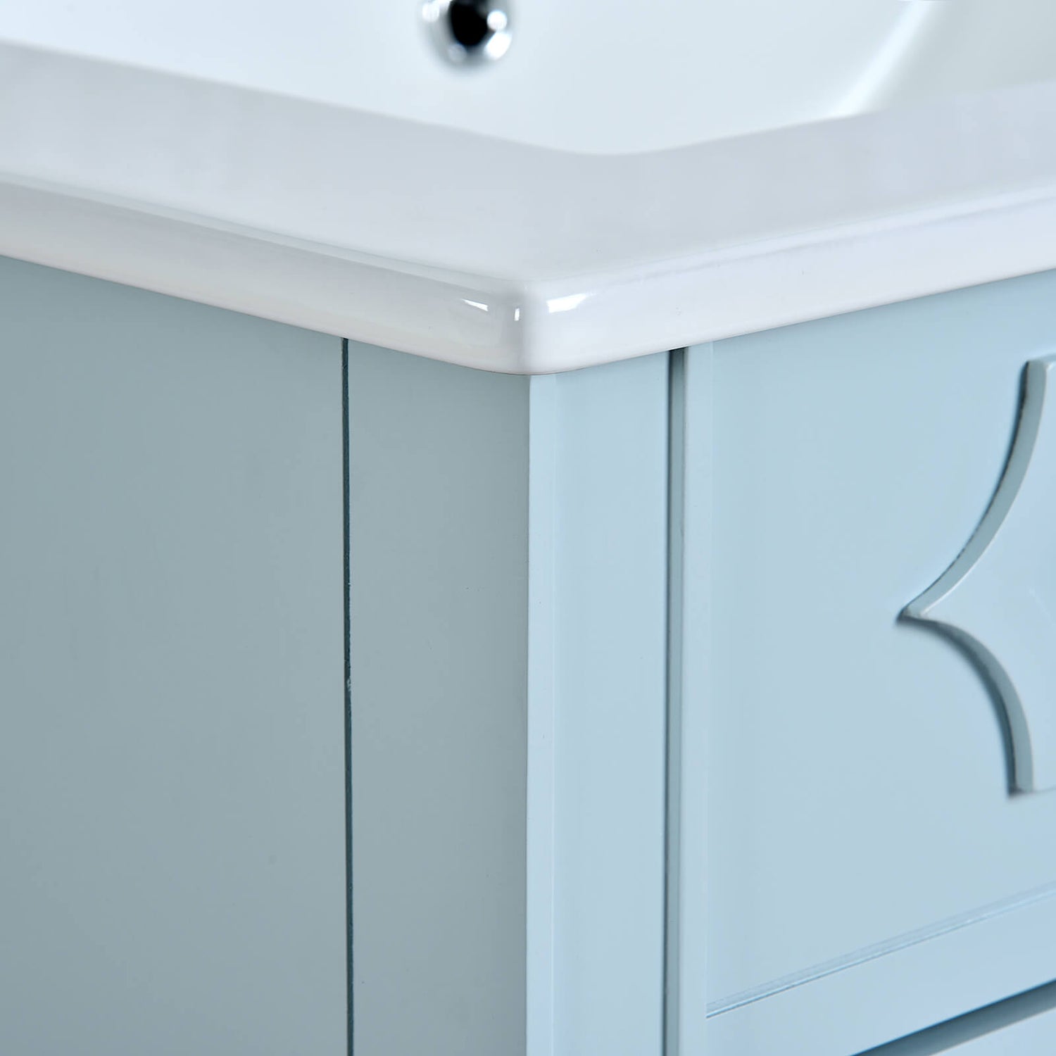 Small space bathroom vanity with soft blue finish and rounded edge countertop