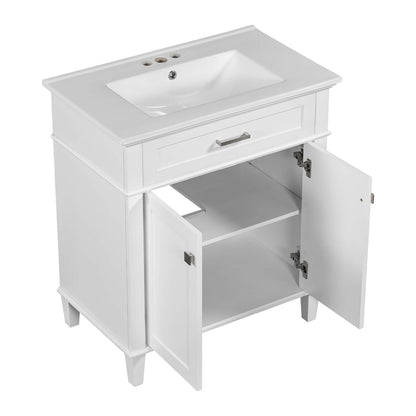 White bathroom vanity with silver metal handles and smooth ceramic sink